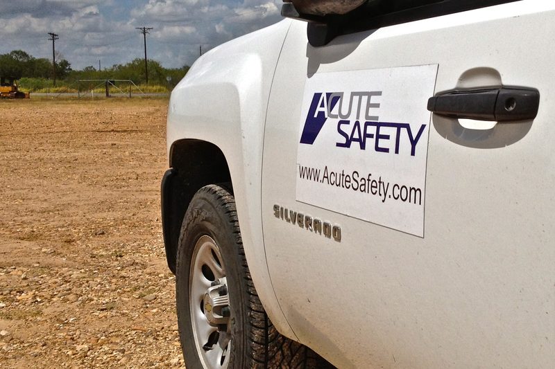 White Acute Safety pickup truck with the company logo on the door